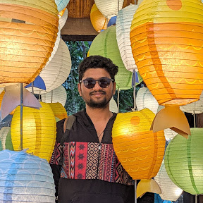 Chaitanya Varun standing among colorful paper lanterns